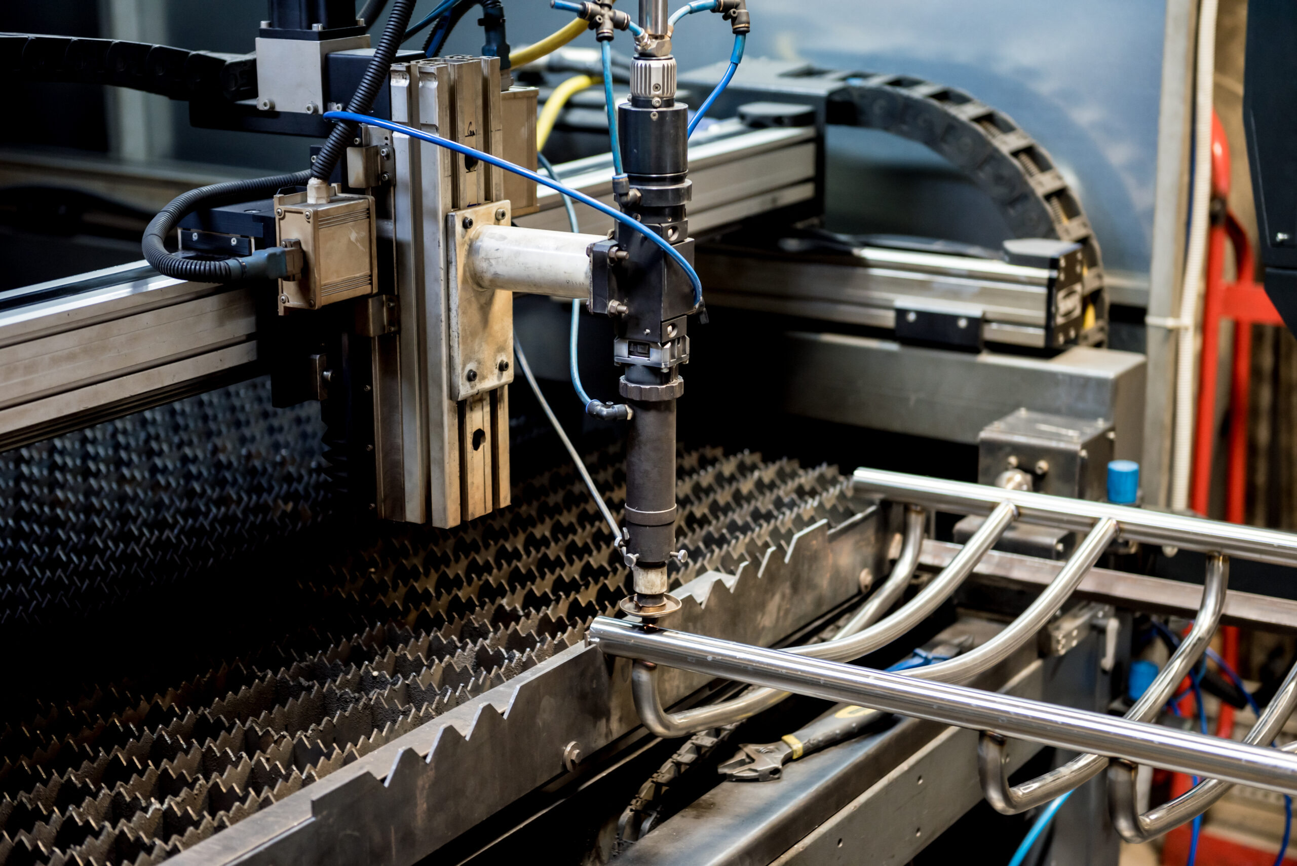 The laser cutting machine cutting the holes on pipes.